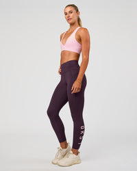Woman wearing Rep Ultra High-Rise 7/8 Legging Pockets - Midnight Plum-Marshmallow | Model:Emelia | Size:S