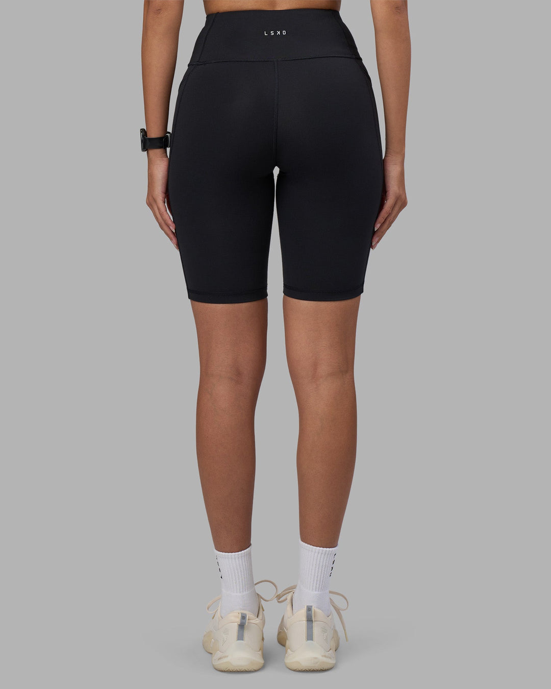 Woman wearing Rep Ultra High-Rise 9" Short Pockets - Black-Power Cobalt | Model:Rhiley | Size:S