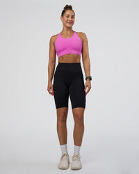 Woman wearing Rep Ultra High-Rise 9" Short Pockets - Black-Ultra Fuchsia | Model:Abbey | Size:S