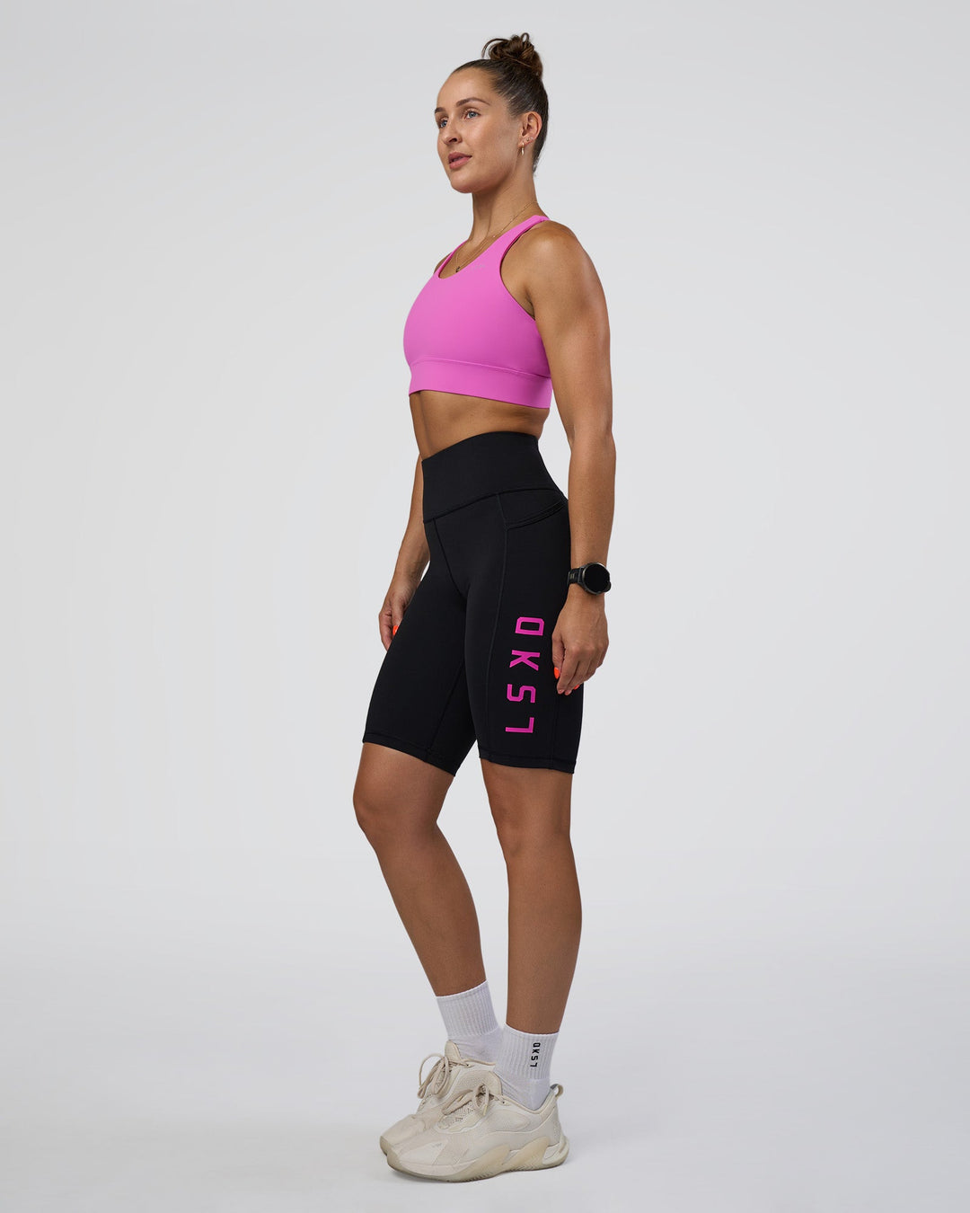 Woman wearing Rep Ultra High-Rise 9" Short Pockets - Black-Ultra Fuchsia | Model:Abbey | Size:S