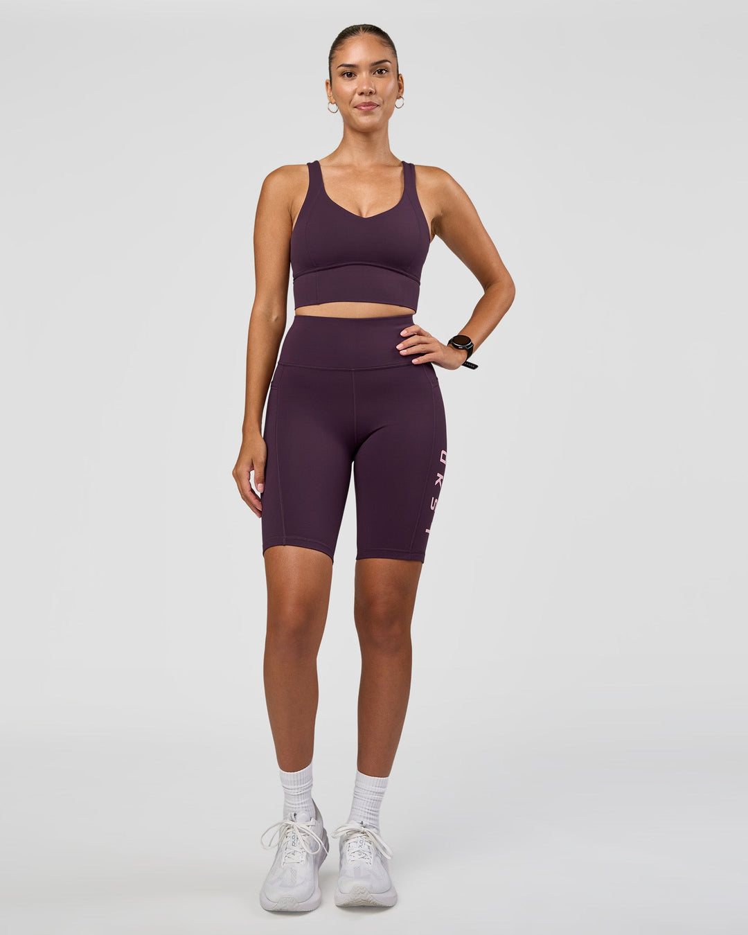 Woman wearing Rep Ultra High-Rise 9" Short Pockets - Midnight Plum-Marshmallow | Model:Rhiley | Size:S