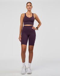 Woman wearing Rep Ultra High-Rise 9" Short Pockets - Midnight Plum-Marshmallow | Model:Rhiley | Size:S
