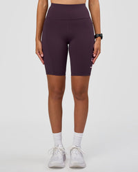 Woman wearing Rep Ultra High-Rise 9" Short Pockets - Midnight Plum-Marshmallow | Model:Rhiley | Size:S