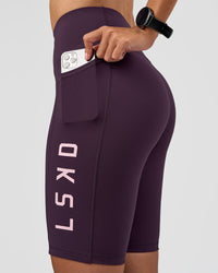 Woman wearing Rep Ultra High-Rise 9" Short Pockets - Midnight Plum-Marshmallow | Model:Rhiley | Size:S