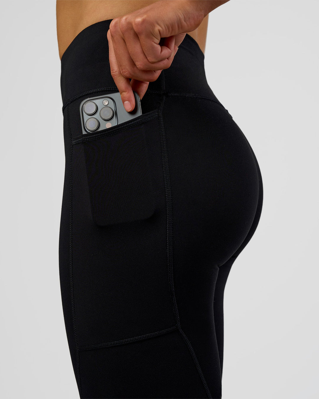 Woman wearing Rep Ultra High-Rise Full Length Legging Pockets - Black-Electric Indigo | Model:Evie | Size:S