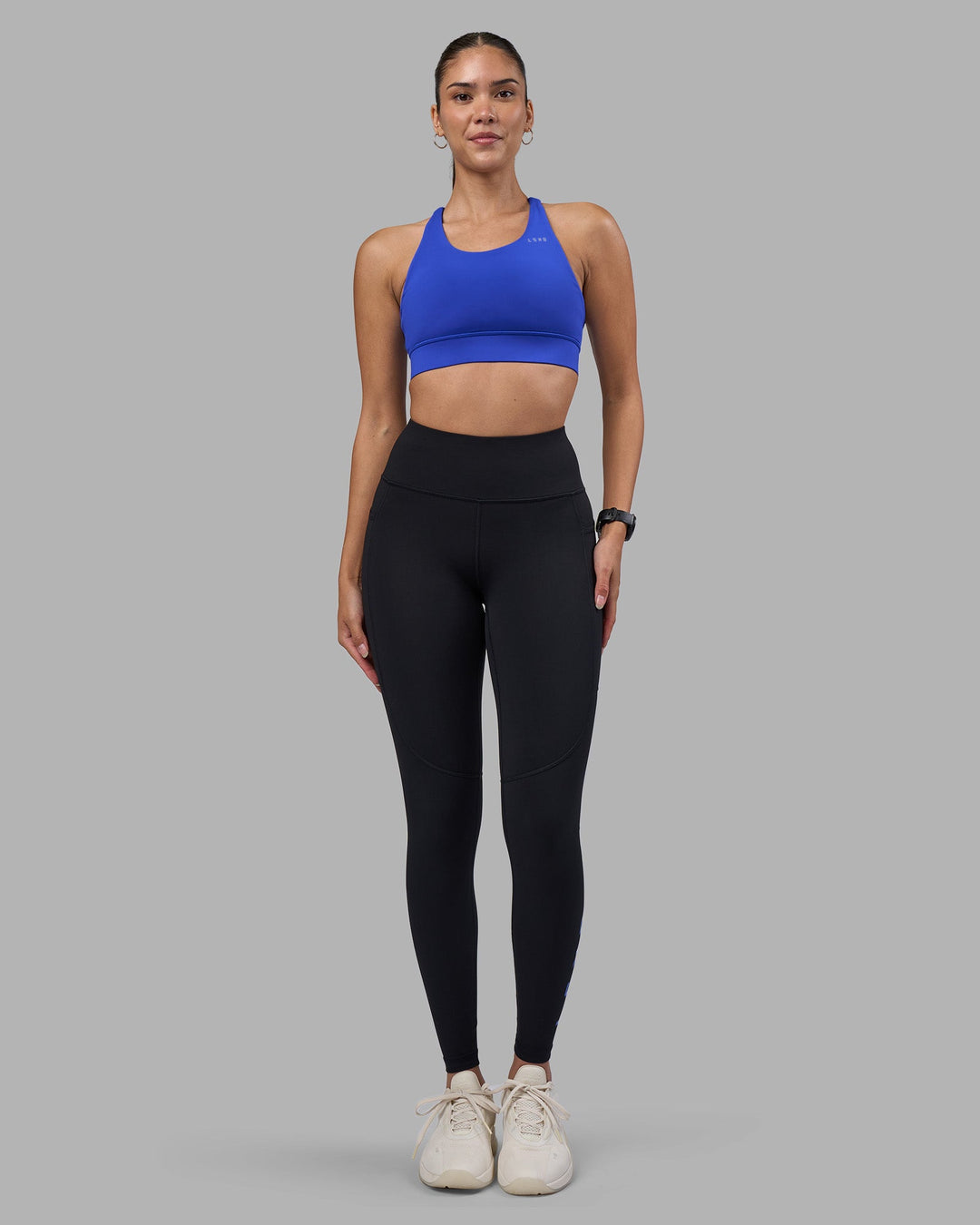Woman wearing Rep Ultra High-Rise Full Length Legging Pockets - Black-Power Cobalt | Model:Rhiley | Size:S