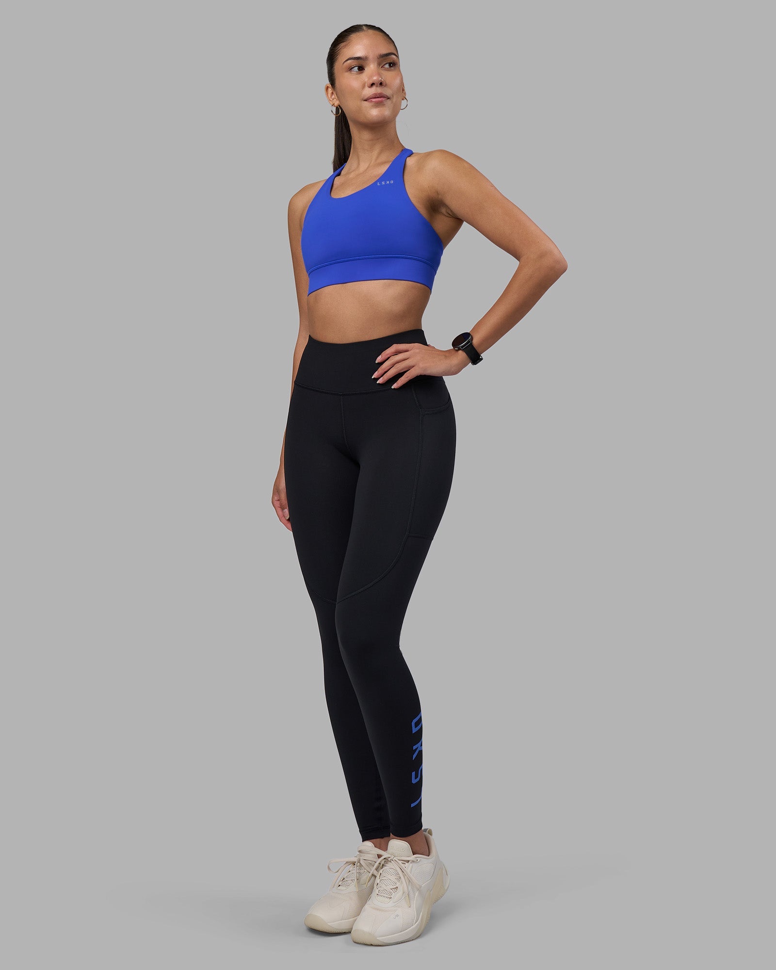 Woman wearing Rep Ultra High-Rise Full Length Legging Pockets - Black-Power Cobalt | Model:Rhiley | Size:S