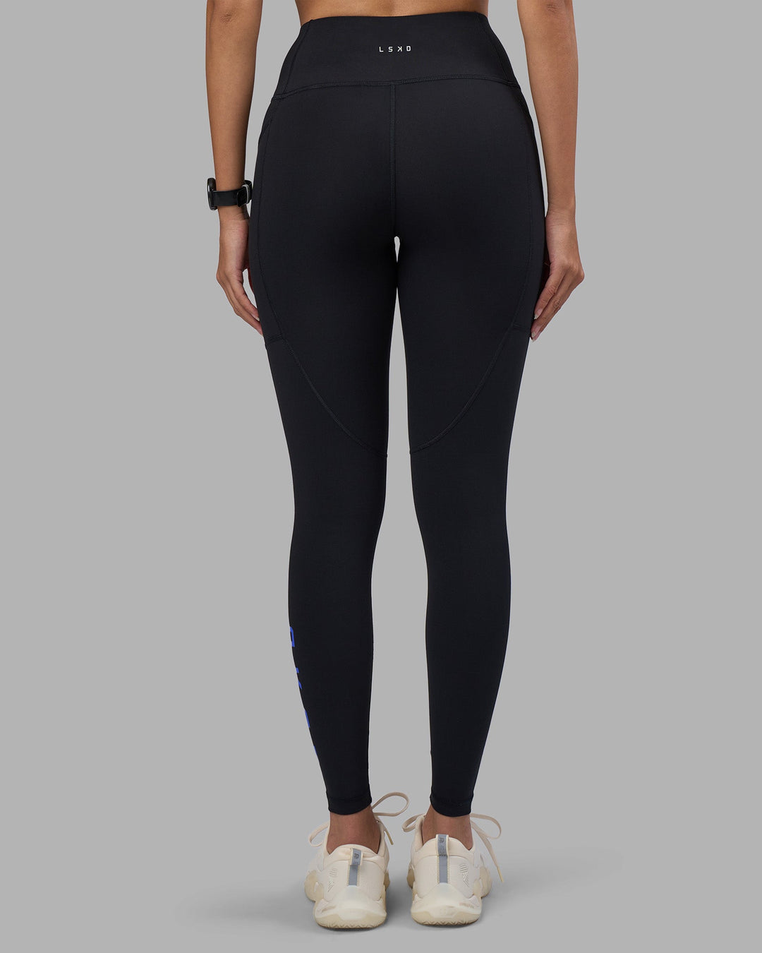 Woman wearing Rep Ultra High-Rise Full Length Legging Pockets - Black-Power Cobalt | Model:Rhiley | Size:S