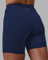 Woman wearing Rep Ultra High-Rise 6" Short Pockets No Logo - Future Navy | Model:Shae | Size:S
