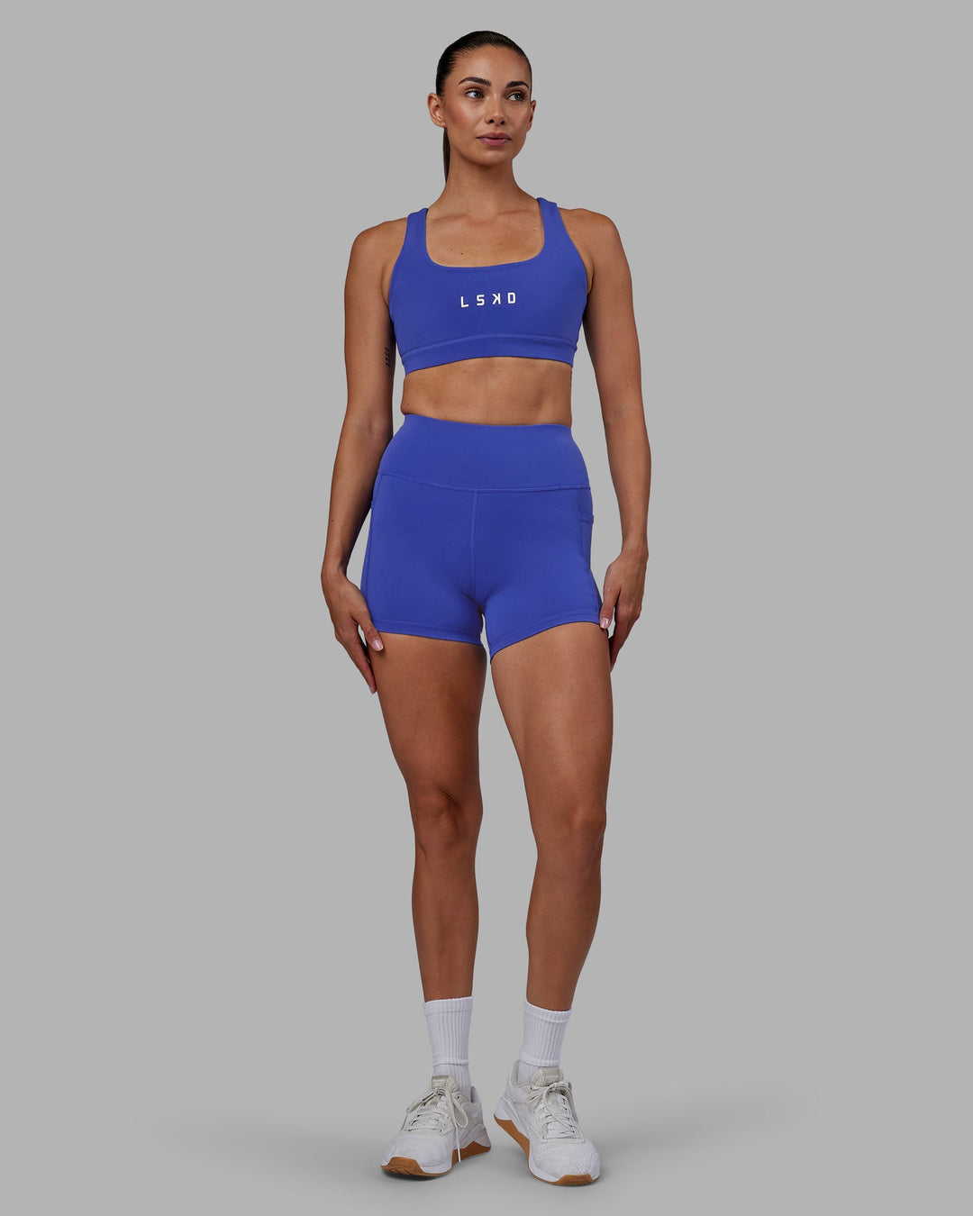 Woman wearing Rep Sports Bra - Power Cobalt-White