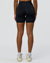 Woman wearing Rep Street Script Ultra High-Rise 6" Short Pockets - Black-White | Model:Rosie | Size:S