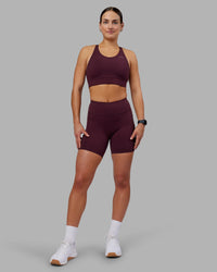 Woman wearing Rep Ultra High-Rise 6" Short Pockets - Cherry Lacquer-White | Model:Keisha | Size:S