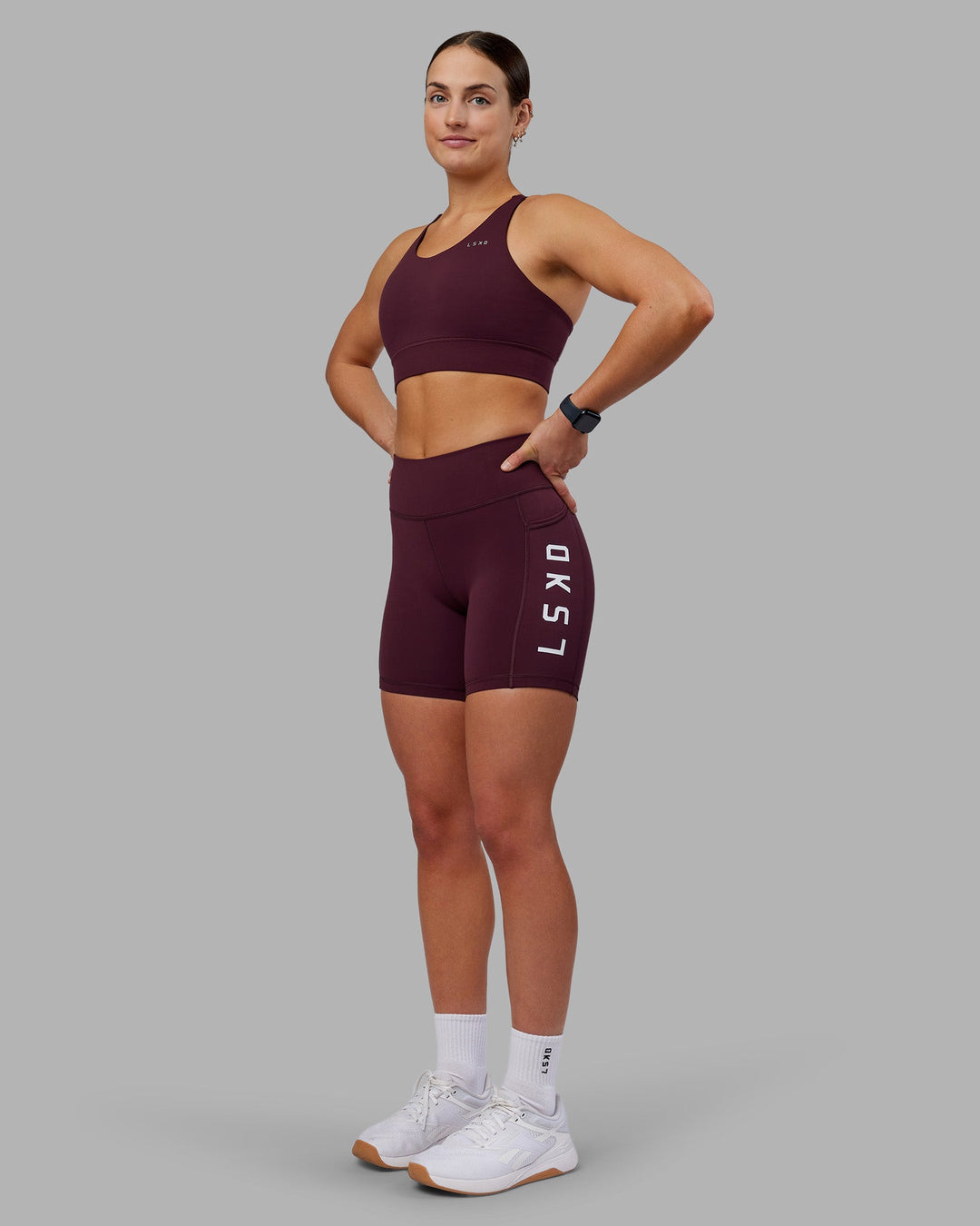 Woman wearing Rep Ultra High-Rise 6" Short Pockets - Cherry Lacquer-White | Model:Keisha | Size:S