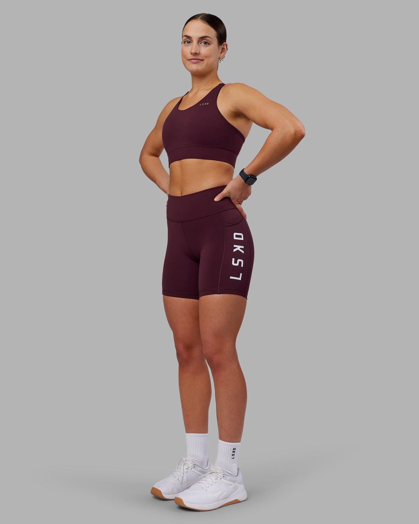 Woman wearing Rep Ultra High-Rise 6" Short Pockets - Cherry Lacquer-White | Model:Keisha | Size:S