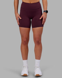 Woman wearing Rep Ultra High-Rise 6" Short Pockets - Cherry Lacquer-White | Model:Keisha | Size:S