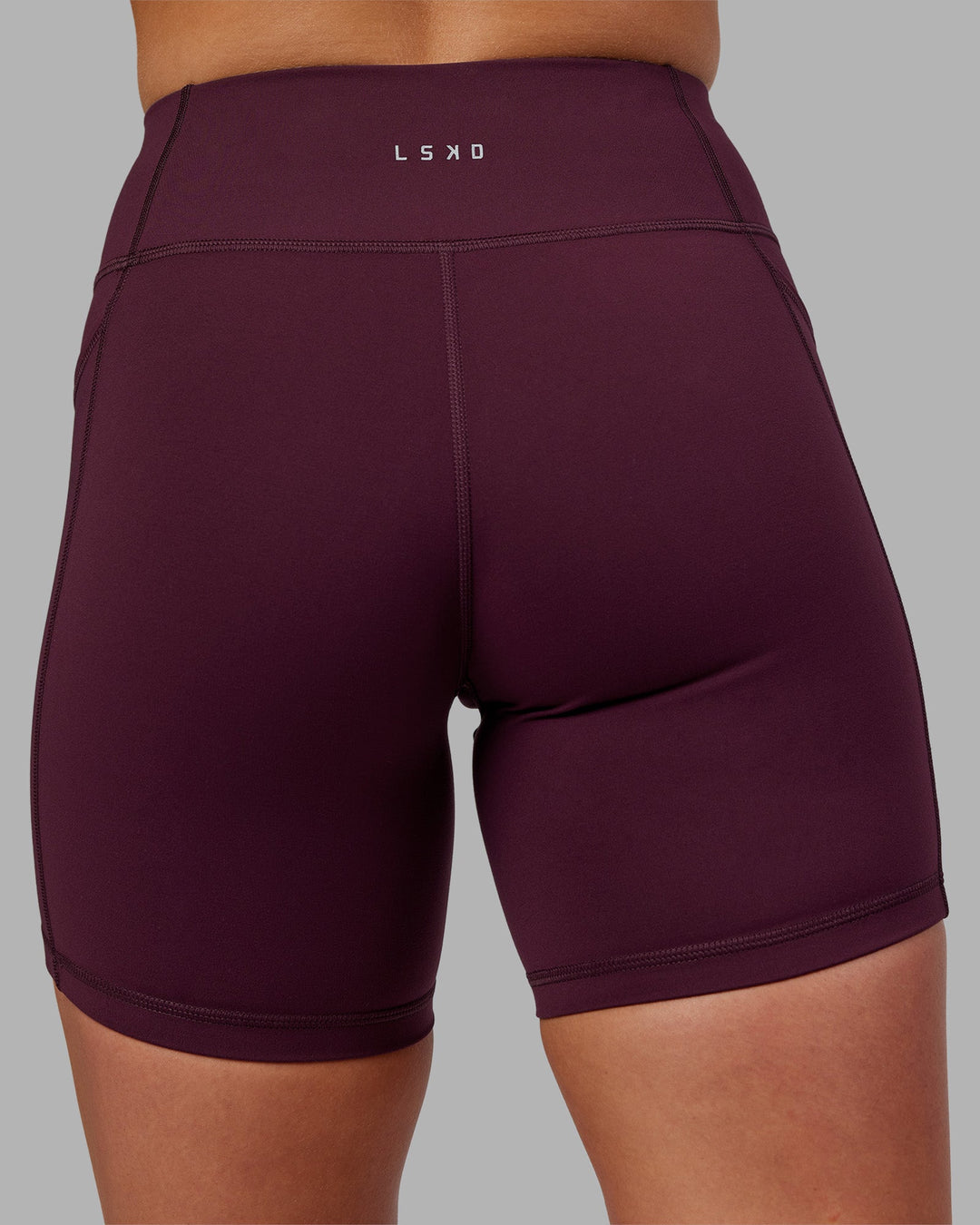 Woman wearing Rep Ultra High-Rise 6" Short Pockets - Cherry Lacquer-White | Model:Keisha | Size:S