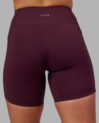 Woman wearing Rep Ultra High-Rise 6" Short Pockets - Cherry Lacquer-White | Model:Keisha | Size:S