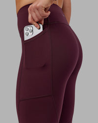 Woman wearing Rep Ultra High-Rise 7/8 Legging Pockets - Cherry Lacquer-White | Model:Keisha | Size:S