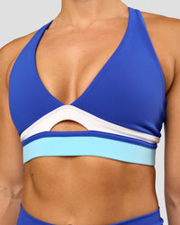 Woman wearing Revitalise Flash Sports Bra - Electric Indigo-Multi | Model:Summer | Size:S