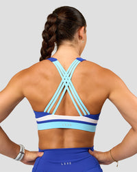 Woman wearing Revitalise Flash Sports Bra - Electric Indigo-Multi | Model:Summer | Size:S