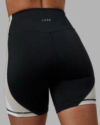 Woman wearing Revitalise Ultra High-Rise 6" Short - Black-Multi | Model:Tylah | Size:S