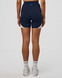Woman wearing Revitalise Ultra High-Rise 6" Short - Future Navy-Multi | Model:Evie | Size:S