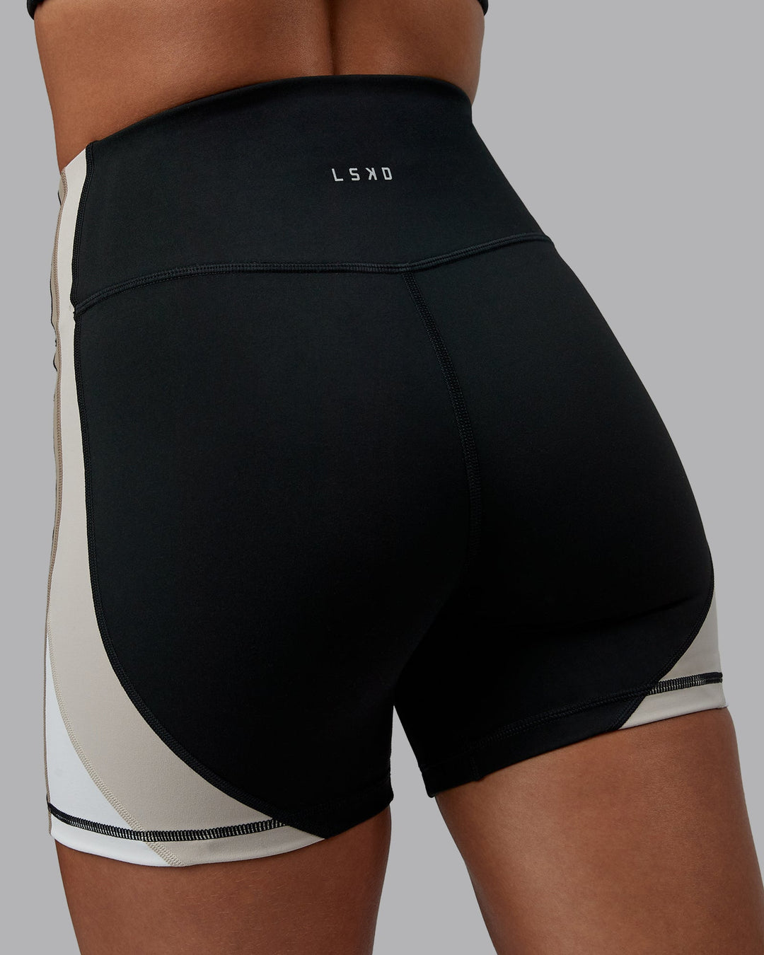 Woman wearing Revitalise Ultra High-Rise 4" Short - Black-Multi | Model:Tylah | Size:S