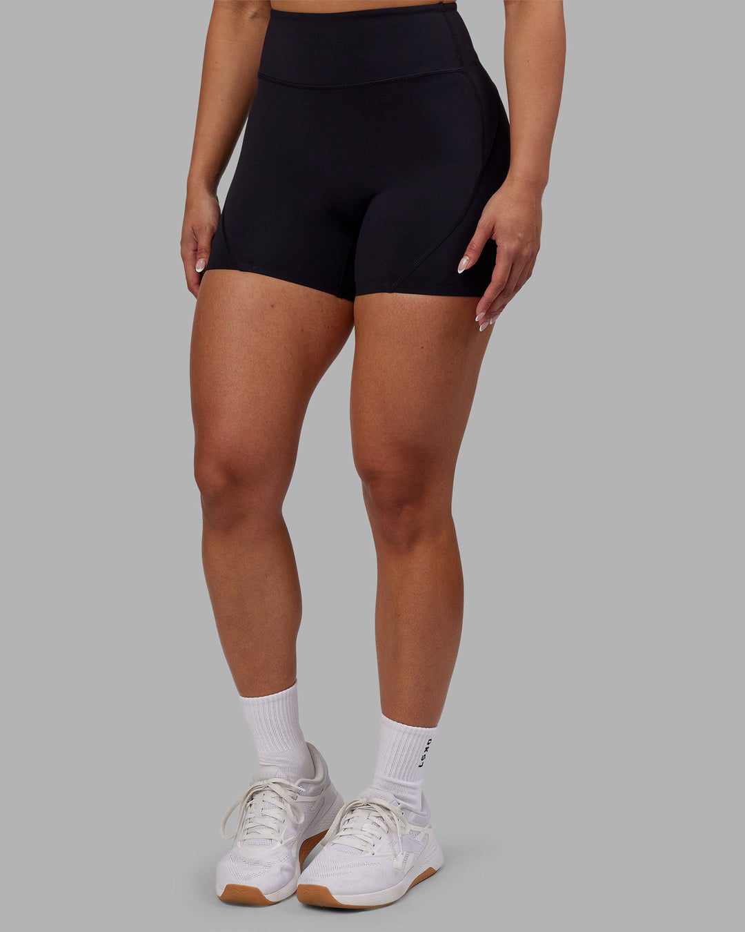 Woman wearing Rhythm Elixir Ultra High-Rise 4" Short - Black | Model:Ayla | Size:S