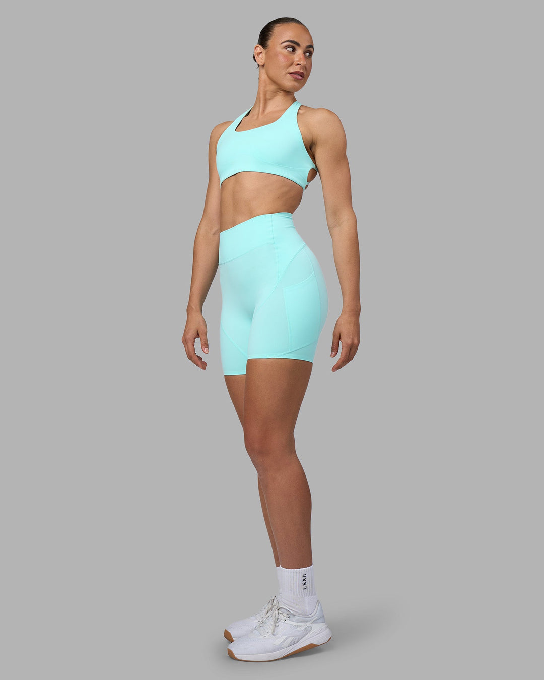 Woman wearing Rhythm Elixir Ultra High-Rise 6" Short Pockets - Island Paradise | Model:Sophie | Size:S