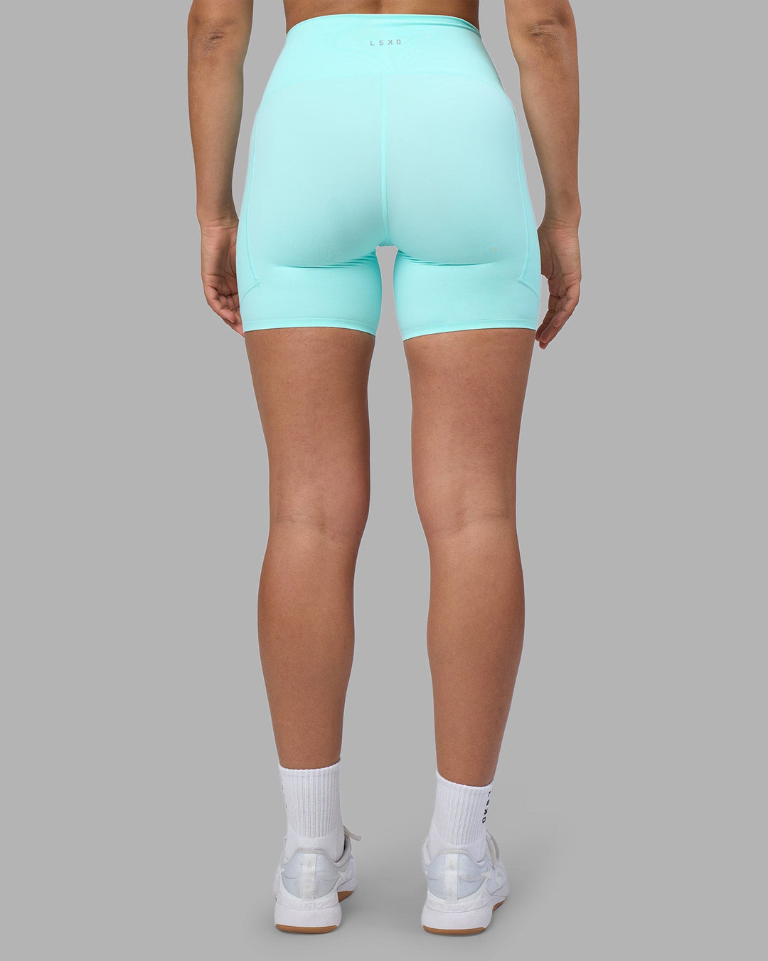 Woman wearing Rhythm Elixir Ultra High-Rise 6" Short Pockets - Island Paradise | Model:Sophie | Size:S