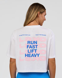 Woman wearing Run Fast Lift Heavy FLXCotton Cropped Tee - White | Model:Amity | Size:S | Thumbnail Index: 0