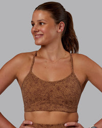 Woman wearing Rush Sports Bra -Caramel-Agile Print | Model:Phoebe | Size:S