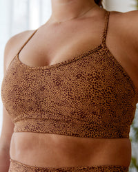 Woman wearing Rush Sports Bra - Caramel-Agile Print | Model:Chantelle | Size: