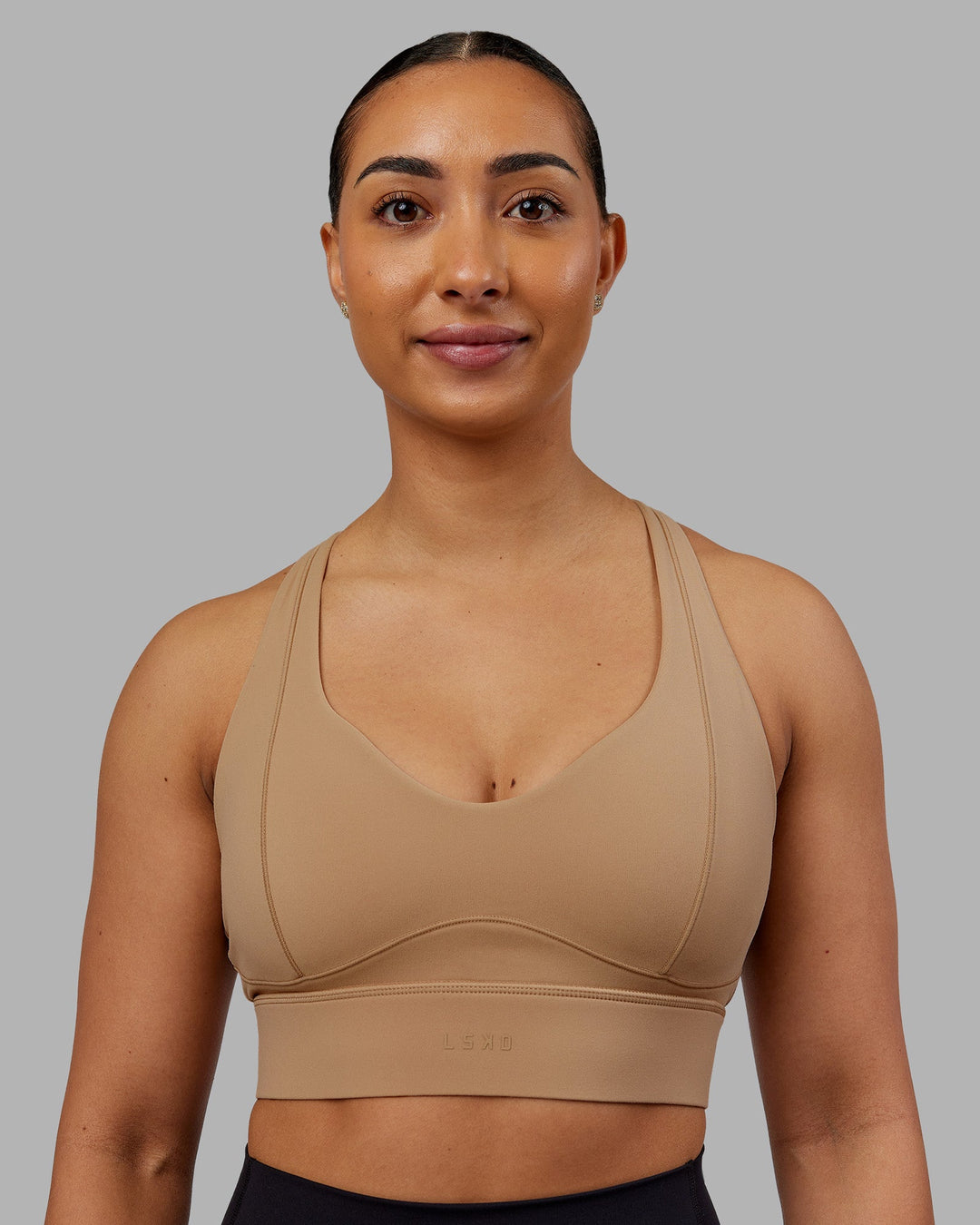 Woman wearing Sculpt Sports Bra - Warm Smoke| Model:Ayla | Size:S