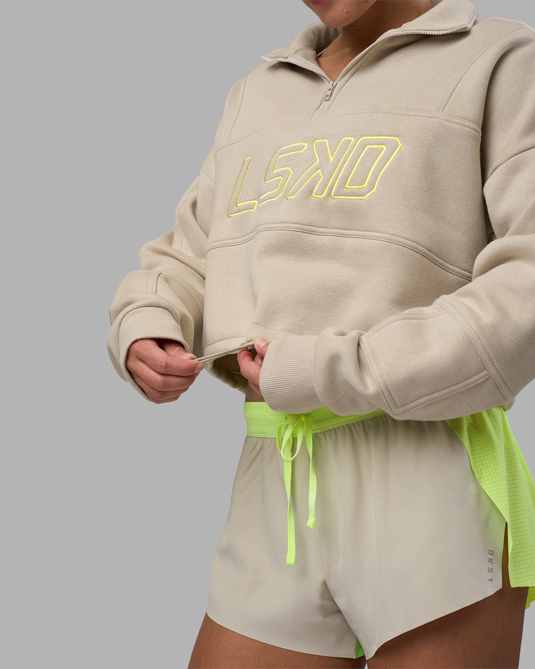 Woman wearing Slam Quarter Zip Sweater - Shale Beige-Lime Glo | Model:Hannah | Size:S