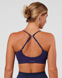 Woman wearing Spark Seamless Ribbed Sports Bra - Future Navy-Ultra Fuchsia | Model:Amity | Size:S