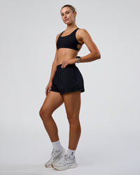 Woman wearing Sport Short 2.5" - Black | Model:Emelia | Size:S