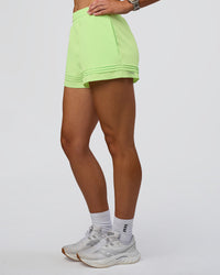 Woman wearing Sport Short 2.5" - Solar Lime | Model:Emelia | Size:S