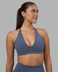 Woman wearing Stamina Pulse Sports Bra - Night Shadow | Model:Rhiley | Size:S