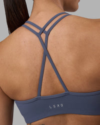 Woman wearing Stamina Pulse Sports Bra - Night Shadow | Model:Rhiley | Size:S