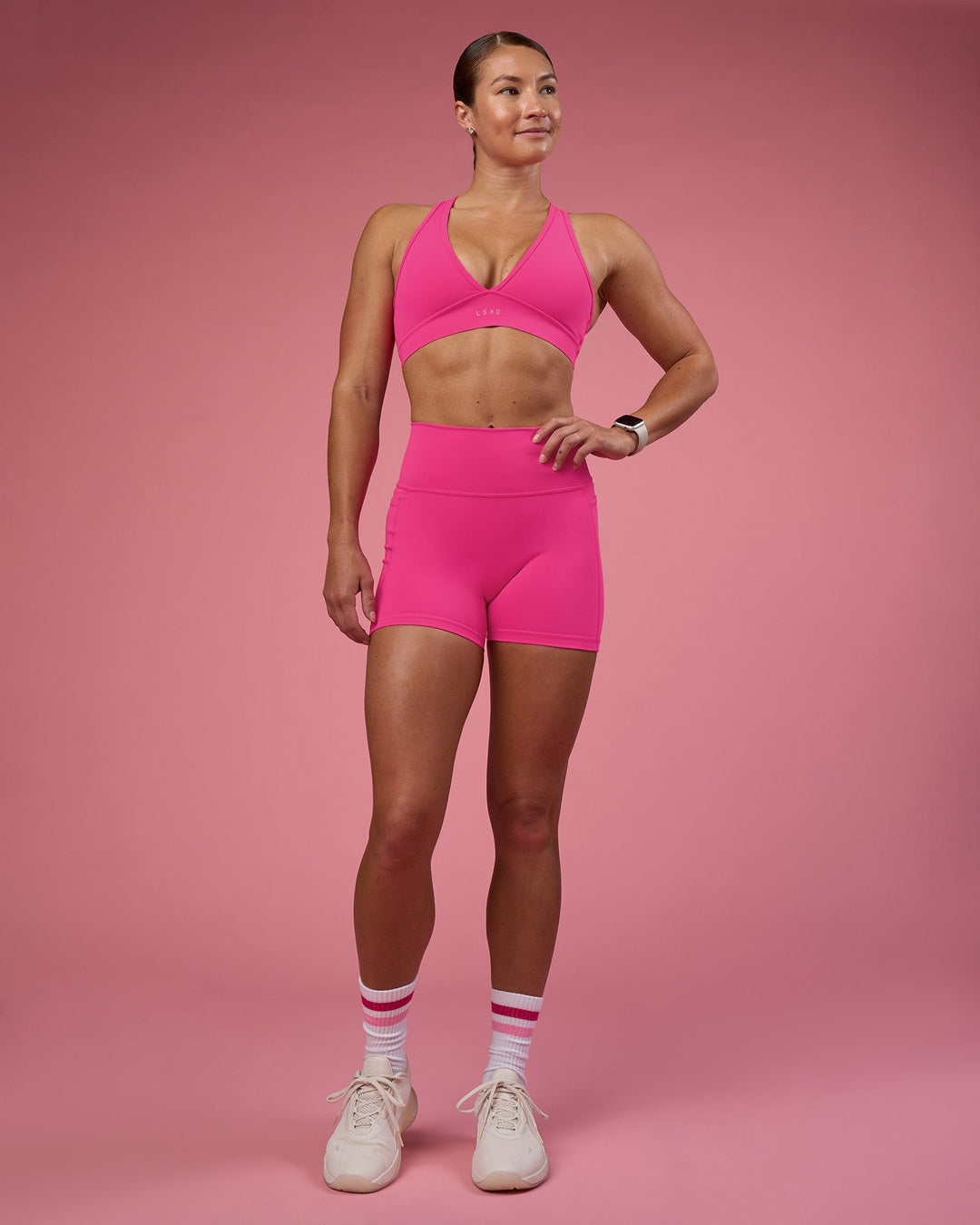 Woman wearing Fusion Ultra High-Rise 4" Short Pockets - Ultra Pink | Model:Hannah | Size:S