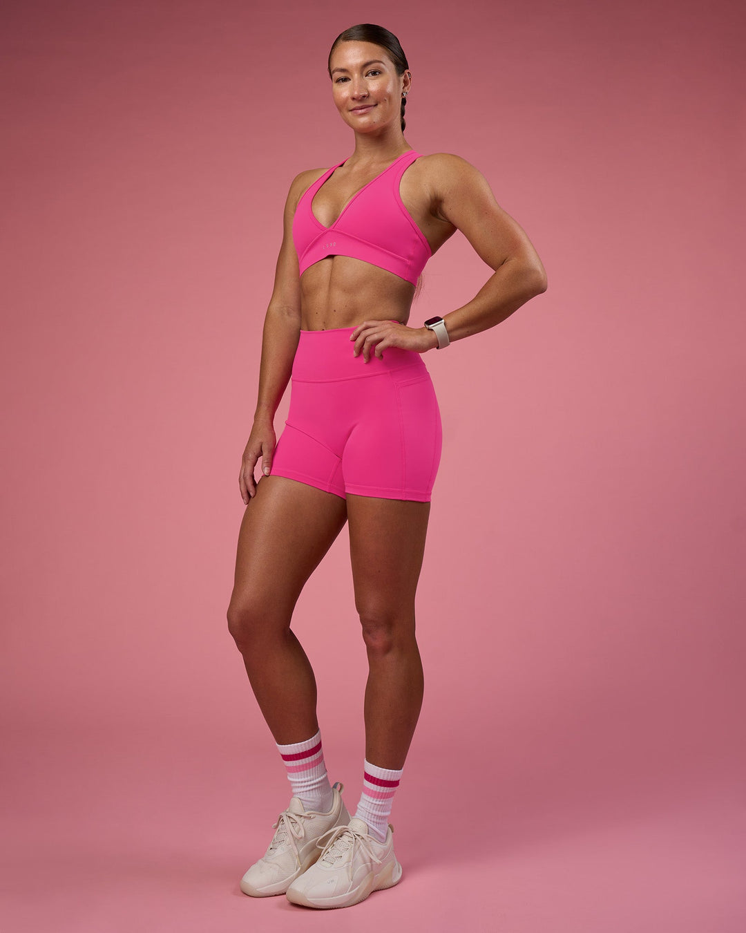 Woman wearing Fusion Ultra High-Rise 4" Short Pockets - Ultra Pink | Model:Hannah | Size:S