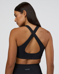 Woman wearing Stamina Sports Bra - Black | Set:true | Angle:back | Model:Ruby | Size:S