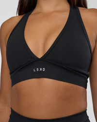 Woman wearing Stamina Sports Bra - Black | Set:true | Angle:closeup | Model:Ruby | Size:S