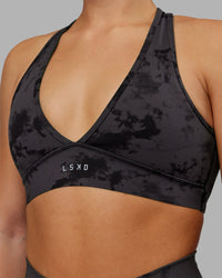 Woman wearing Stamina Sports Bra - Black Tie Dye | Set:true | Angle:closeup | Model:Keisha | Size:S
