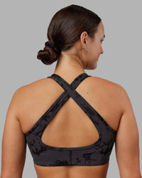 Woman wearing Stamina Sports Bra - Black Tie Dye | Set:true | Angle:back | Model:Keisha | Size:S
