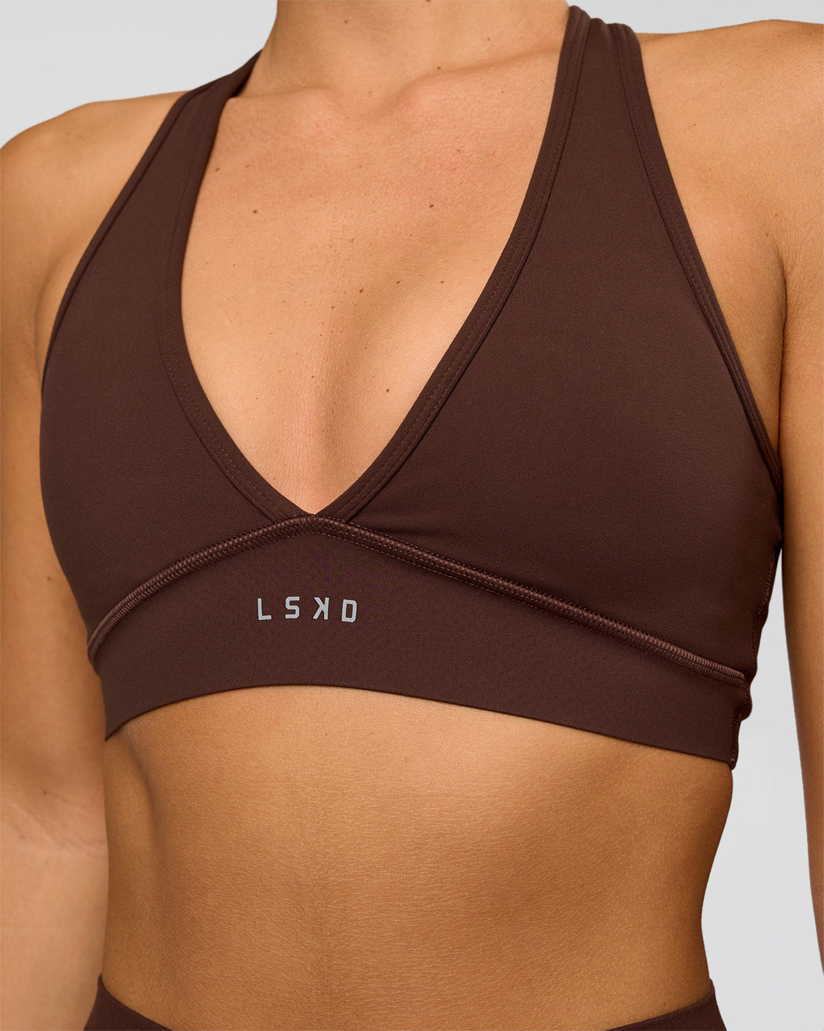 Woman wearing Stamina Sports Bra - Hot Chocolate | Set:true | Angle:closeup | Model:Amity | Size:S