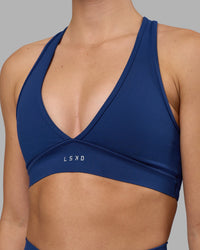 Woman wearing Stamina Sports Bra - Midnight Blue | Set:true | Angle:closeup | Model:Charlize | Size:S