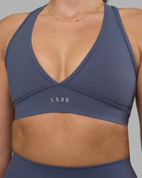 Woman wearing Stamina Sports Bra - Night Shadow | Set:true | Angle:closeup | Model:Phoebe | Size:S