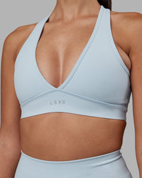 Woman wearing Stamina Sports Bra - Skyride | Set:true | Angle:closeup | Model:Rhiley | Size:S